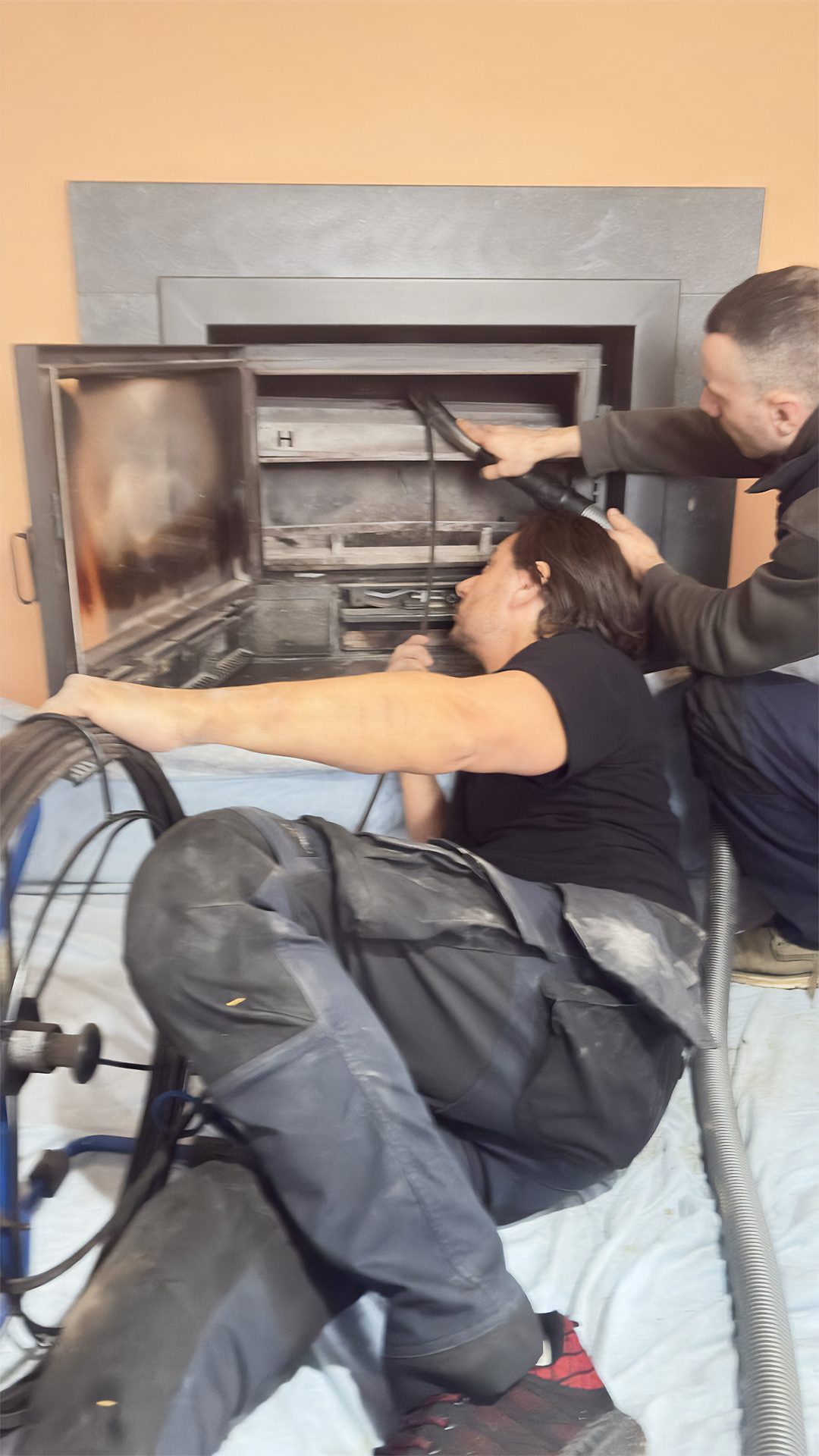 Équipe Plumby réalisant le ramonage d'un insert de cheminée